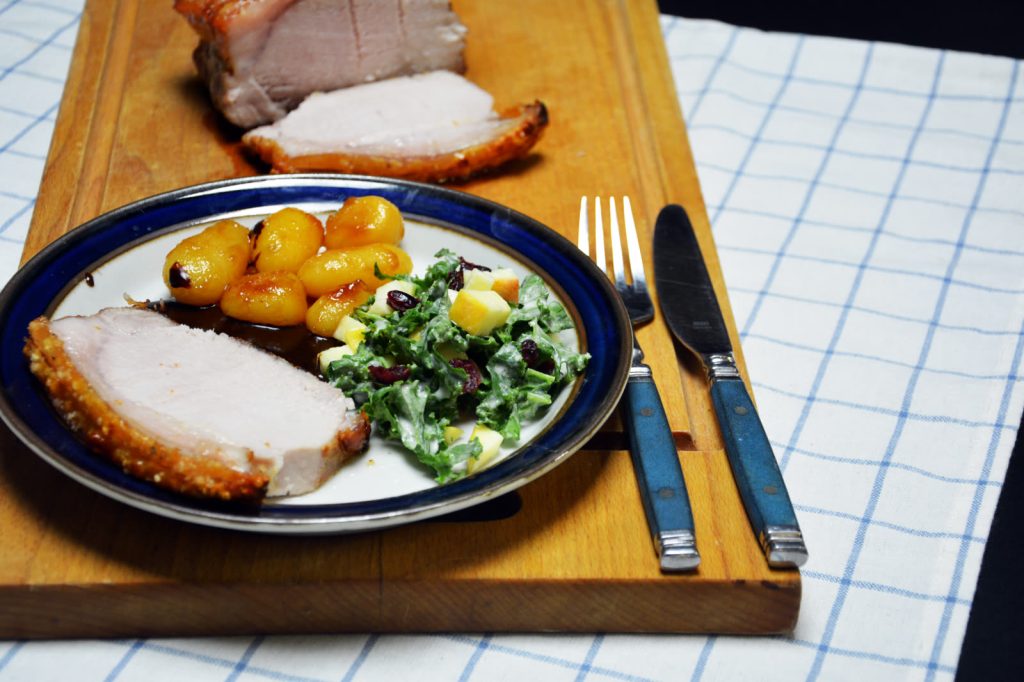Schab sous vide pokrojony w plastry z chrupiącą skórką, podany z karmelizowanymi ziemniakami, sosem pieczeniowym i surówką z jarmużu